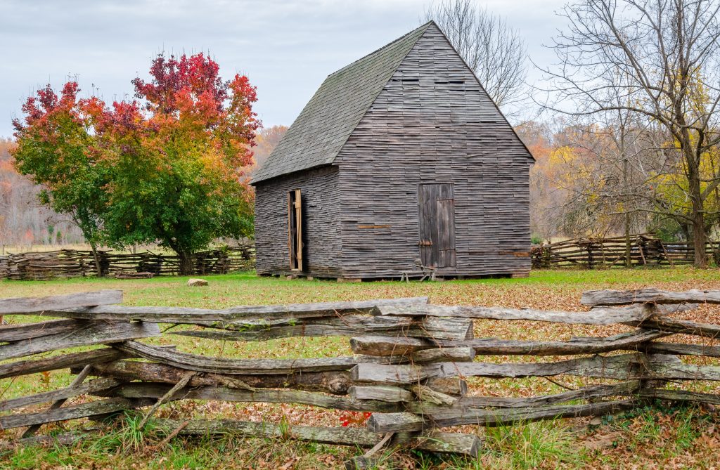 Old Farm House in Fall with wooden fence 