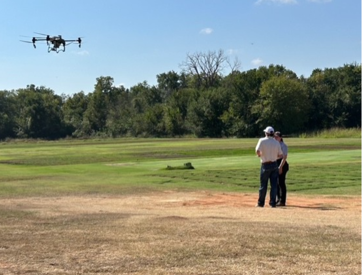 Big Drone flying in field 